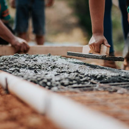 Rocky Ridge Handyman smoothing fresh concrete sidewalk installation in Colorado