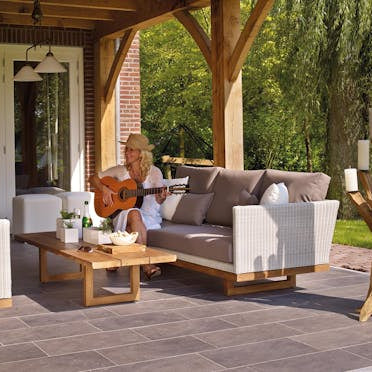 Outdoor covered patio renovation with furniture and tile flooring