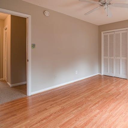 Entryway and dining room featuring crown molding, wainscoting, and detailed trim work with coffered ceiling in Colorado home