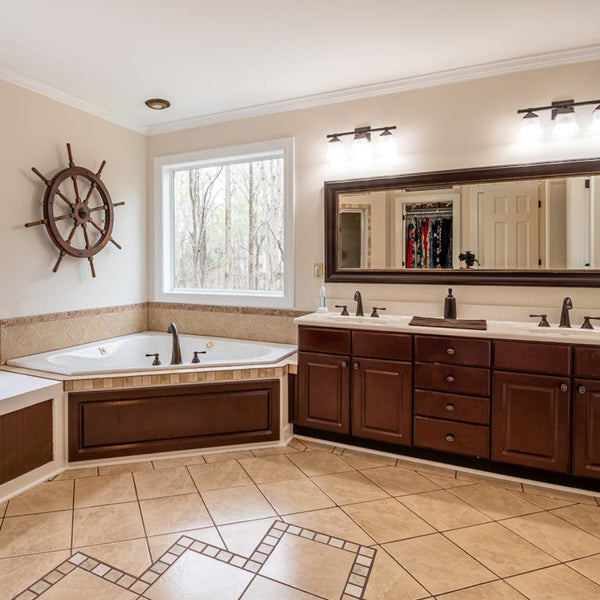 Master bathroom remodel in Denver Colorado featuring double sink vanity dark wood cabinets and corner soaking tub