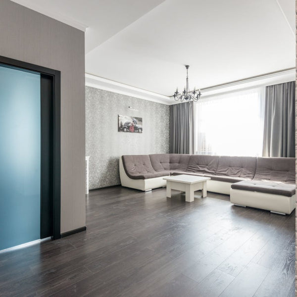Dark wood look laminate flooring installed in modern living room with floating plank layout