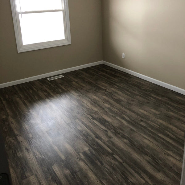 luxury vinyl tile flooring installed in residential bedroom showing dark wood look luxury vinyl tile flooring in denver colorado