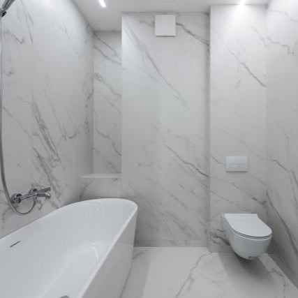 Modern marble bathroom remodel with new bathtub toilet and sink installed by Rocky Ridge Handyman in Denver Colorado