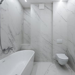 Modern marble bathroom remodel with new bathtub toilet and sink installed by Rocky Ridge Handyman in Denver Colorado