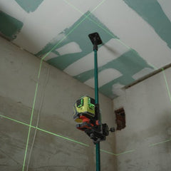 Laser level tool projecting green lines on ceiling during drywall installation in Denver Colorado