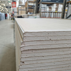 Stacked drywall sheets ready for home repair and remodeling projects in Brighton Colorado