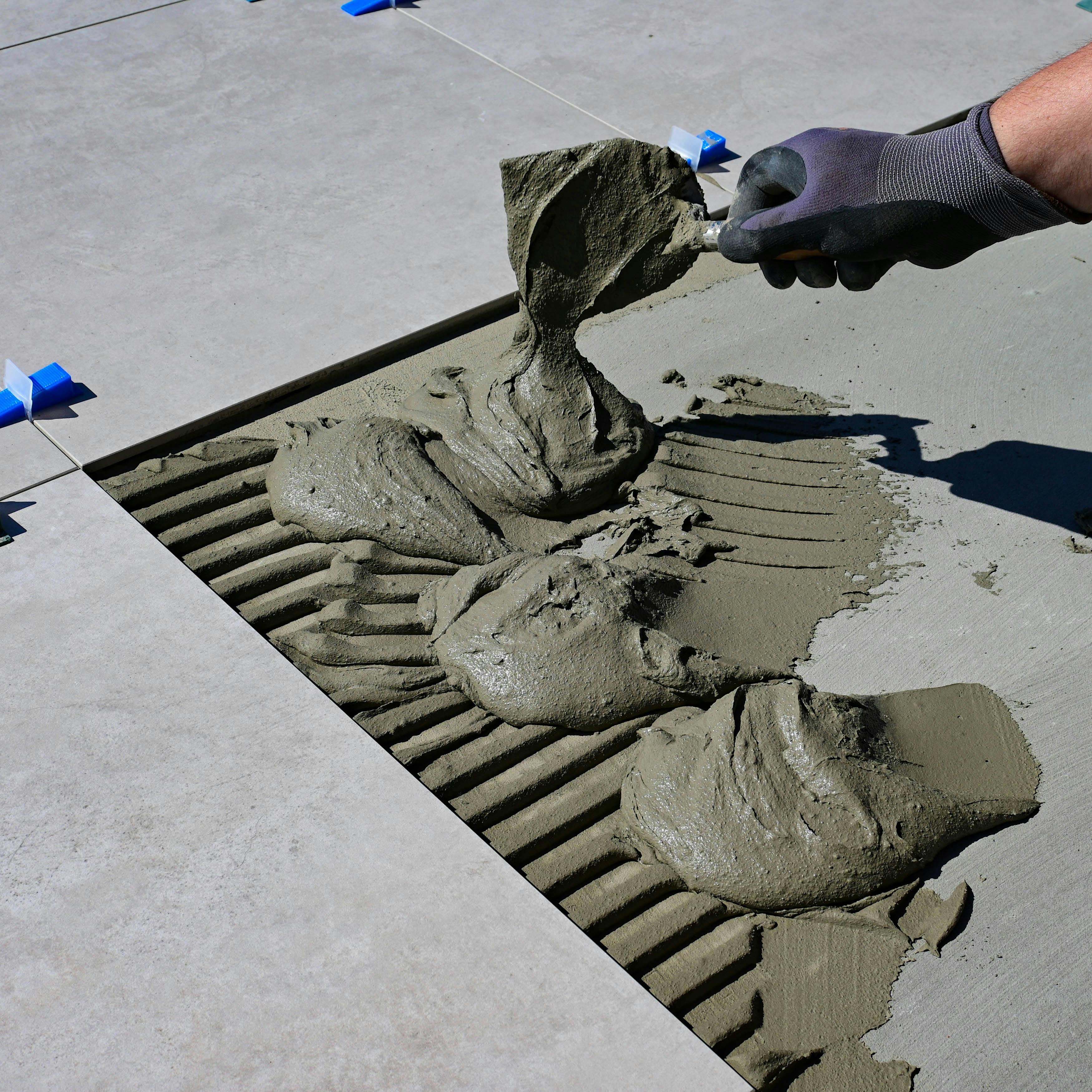 Mortar being applied for large floor tile installation during remodeling project in Westminster Colorado
