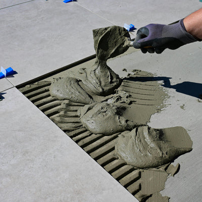 Mortar being applied for large floor tile installation during remodeling project in Westminster Colorado