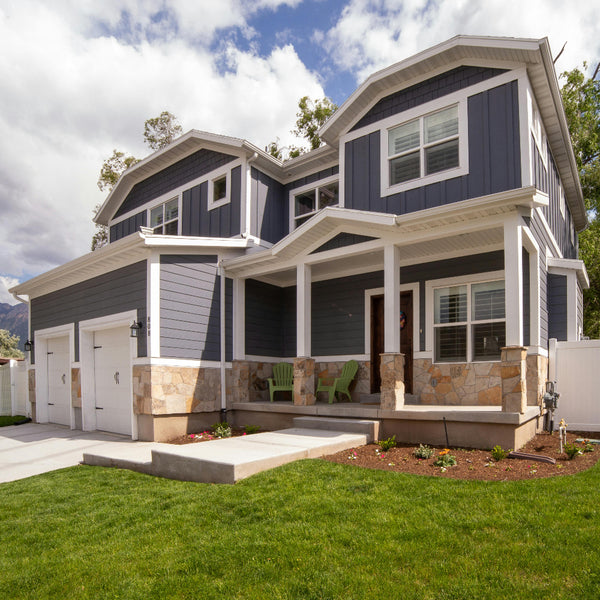 siding installation in Denver Colorado on a modern two story home with gray exterior siding white trim stone accents and front porch